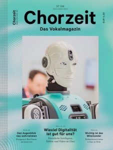 Chorzeit Nr. 106 (Juli/August 2023) Ein moderner Roboter mit Kamera steht im Fokus vor verschwommenem Hintergrund. Die Themen sind Digitalisierung im Chor, Künstliche Intelligenz und Probenarbeit.